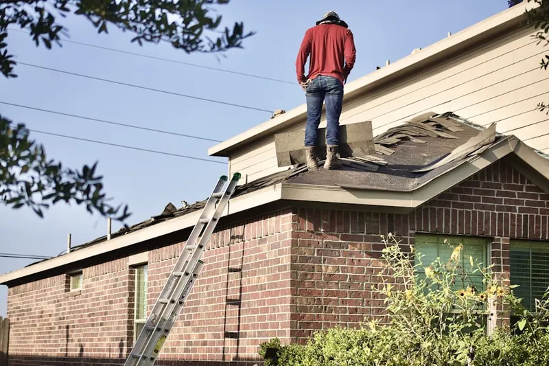 Professional roofer working on a residential roof in Roytown